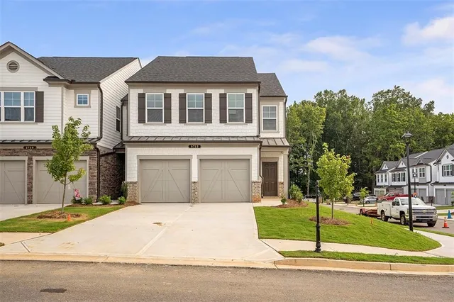 a front view of a house with a garden and plants