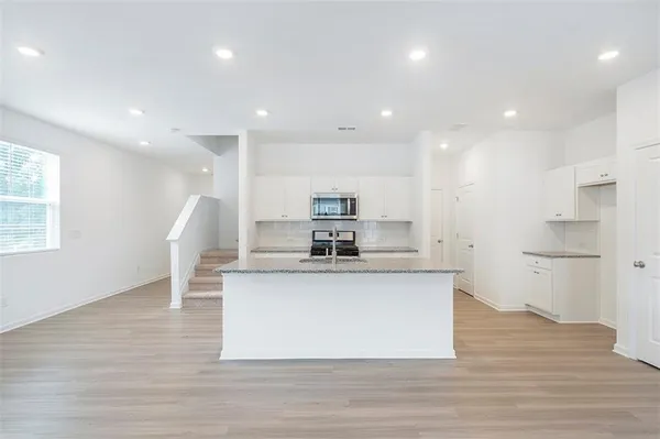 a view of kitchen with cabinets and wooden floor