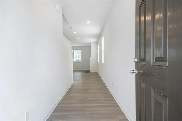 a view of a hallway with wooden floor