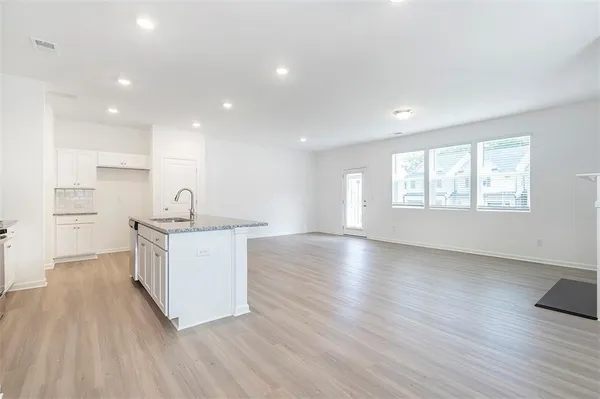 a kitchen with sink and wooden floor