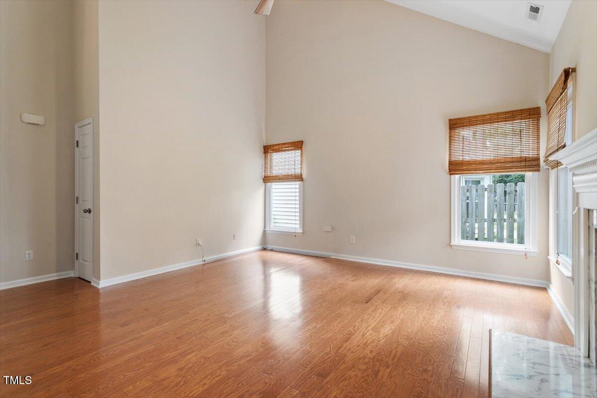 5821 Edgebury Road Raleigh, NC 27613 - Photo 11 of 37 an empty room with wooden floor and windows