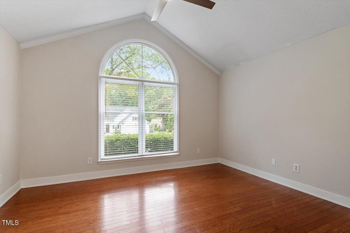 5821 Edgebury Road Raleigh, NC 27613 - Photo 16 of 37 an empty room with wooden floor and a window