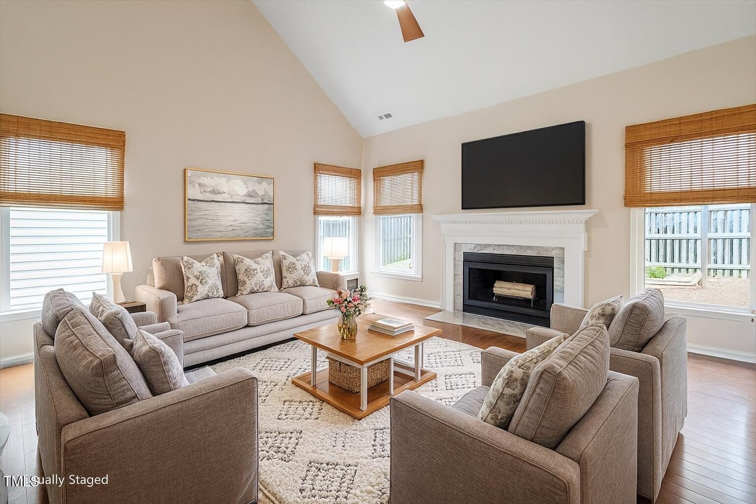 5821 Edgebury Road Raleigh, NC 27613 - Photo 8 of 37 a living room with furniture a flat screen tv and a fireplace