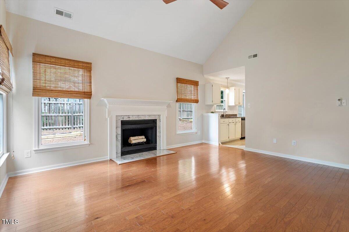 5821 Edgebury Road Raleigh, NC 27613 - Photo 10 of 37 a view of a kitchen with a sink a fireplace and wooden floor