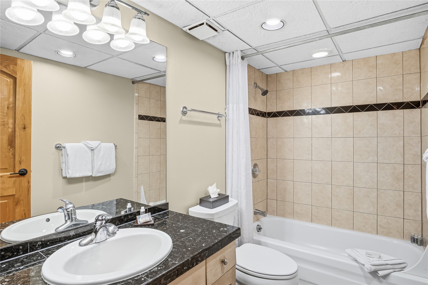 611 Village Road, Unit 24260 Breckenridge, CO 80424 - Photo 27 of 50 a bathroom with a granite countertop sink toilet a mirror and shower