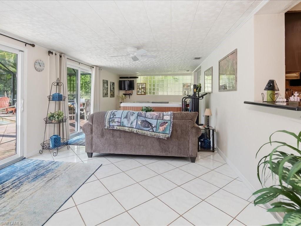 3890 27th Avenue Southwest Naples, FL 34117 - Photo 12 of 38 a living room with a couch and a table