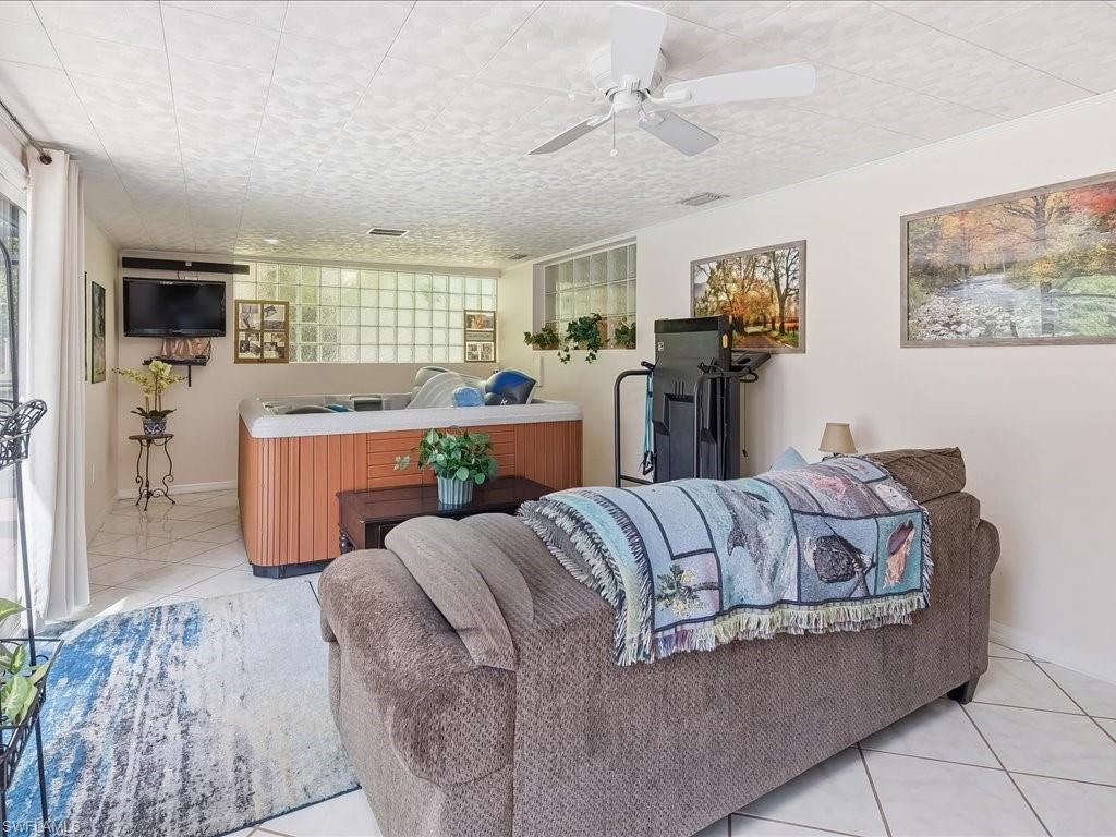 3890 27th Avenue Southwest Naples, FL 34117 - Photo 13 of 38 a living room with furniture and a window
