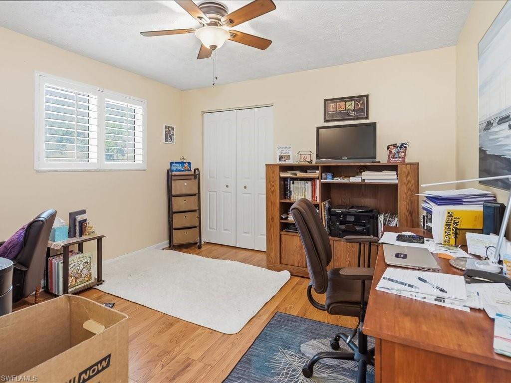 3890 27th Avenue Southwest Naples, FL 34117 - Photo 18 of 38 a bedroom with furniture and a flat screen tv