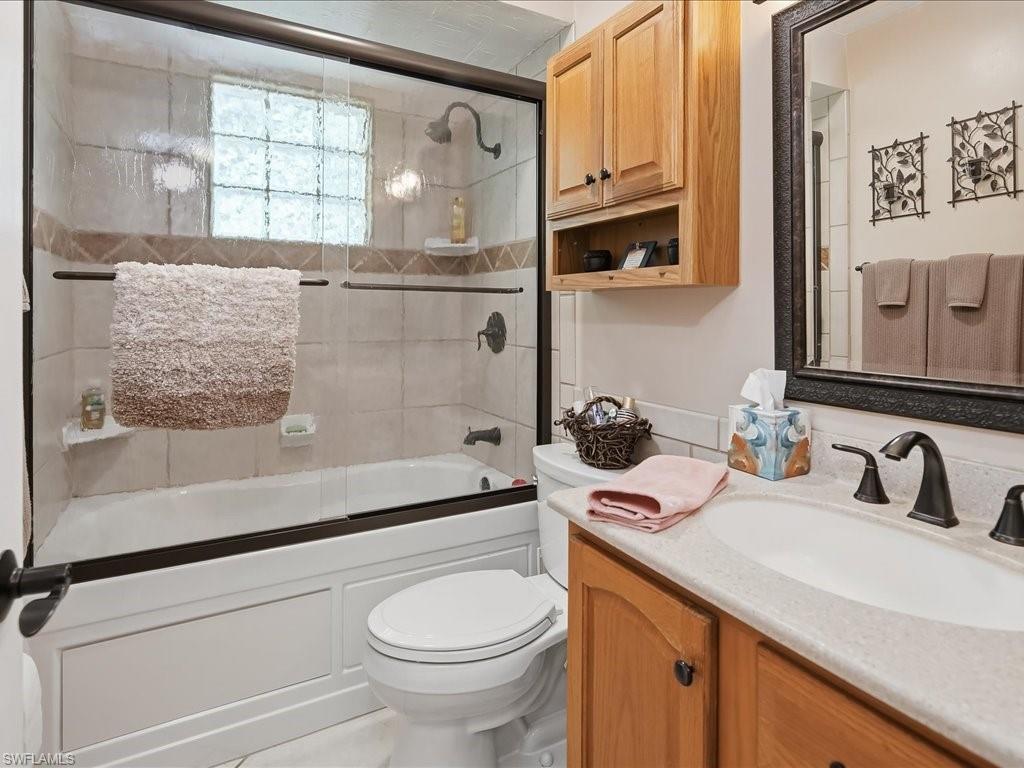 3890 27th Avenue Southwest Naples, FL 34117 - Photo 20 of 38 a bathroom with a sink a toilet and a bathtub next to a window