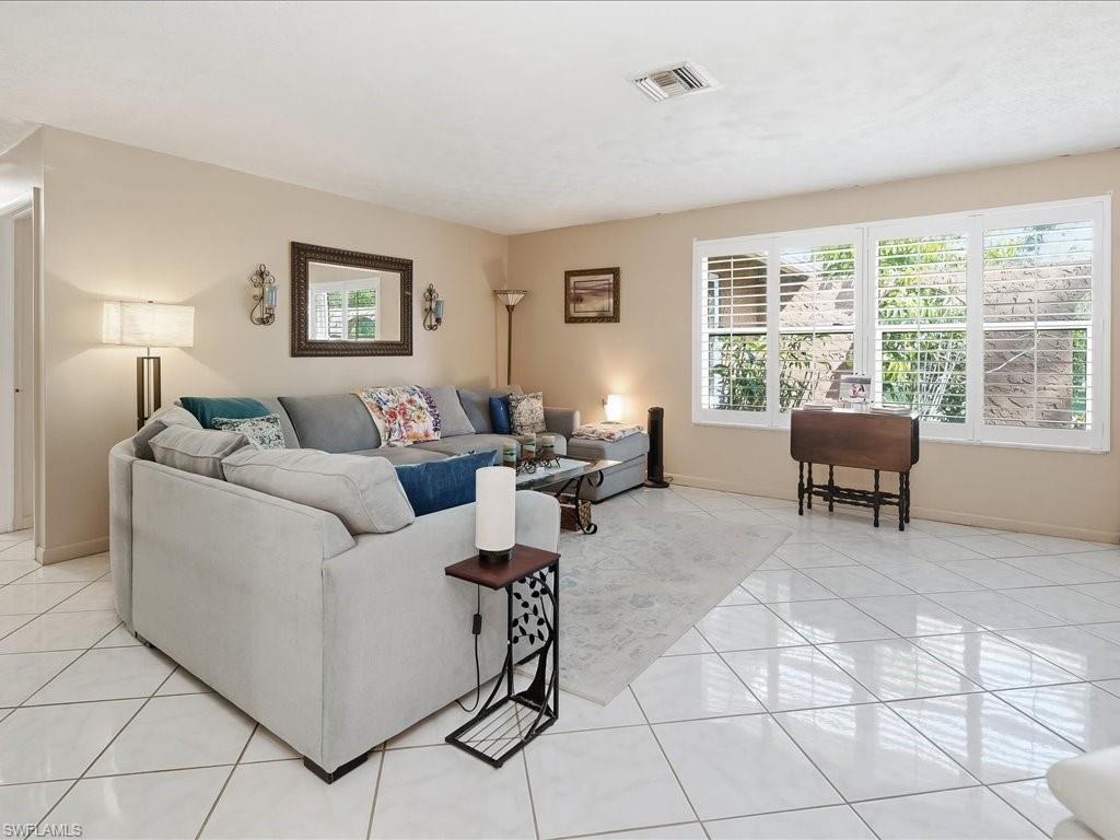 3890 27th Avenue Southwest Naples, FL 34117 - Photo 2 of 38 a living room with furniture and a window