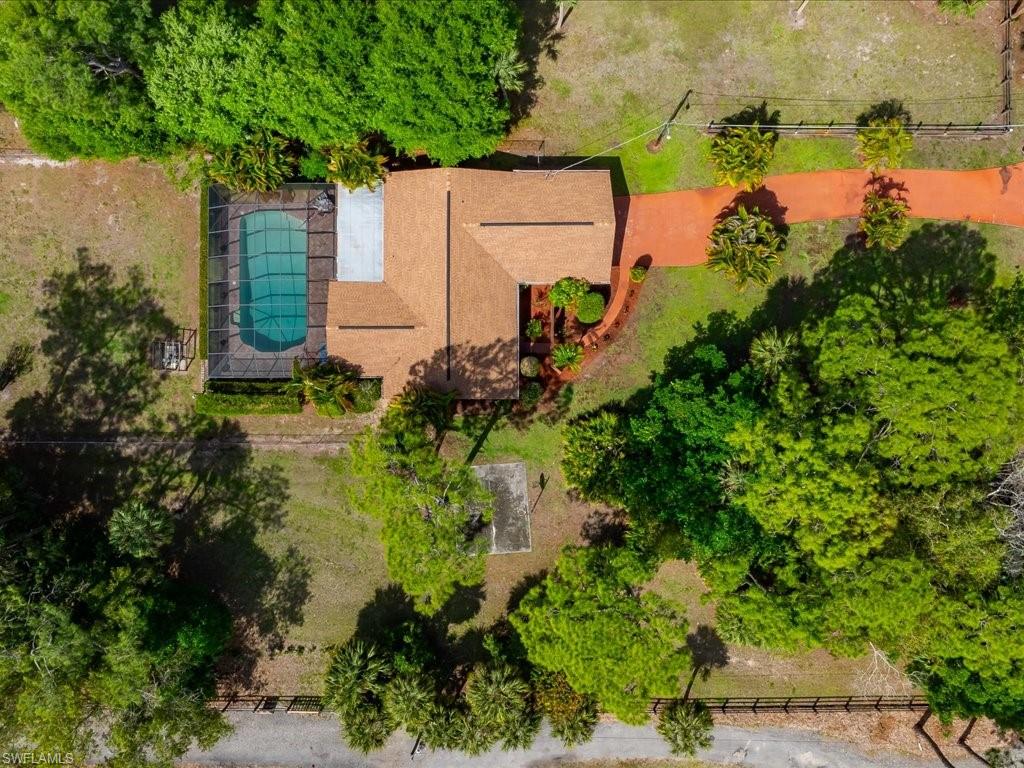 3890 27th Avenue Southwest Naples, FL 34117 - Photo 25 of 38 an aerial view of a house with a yard and lake view