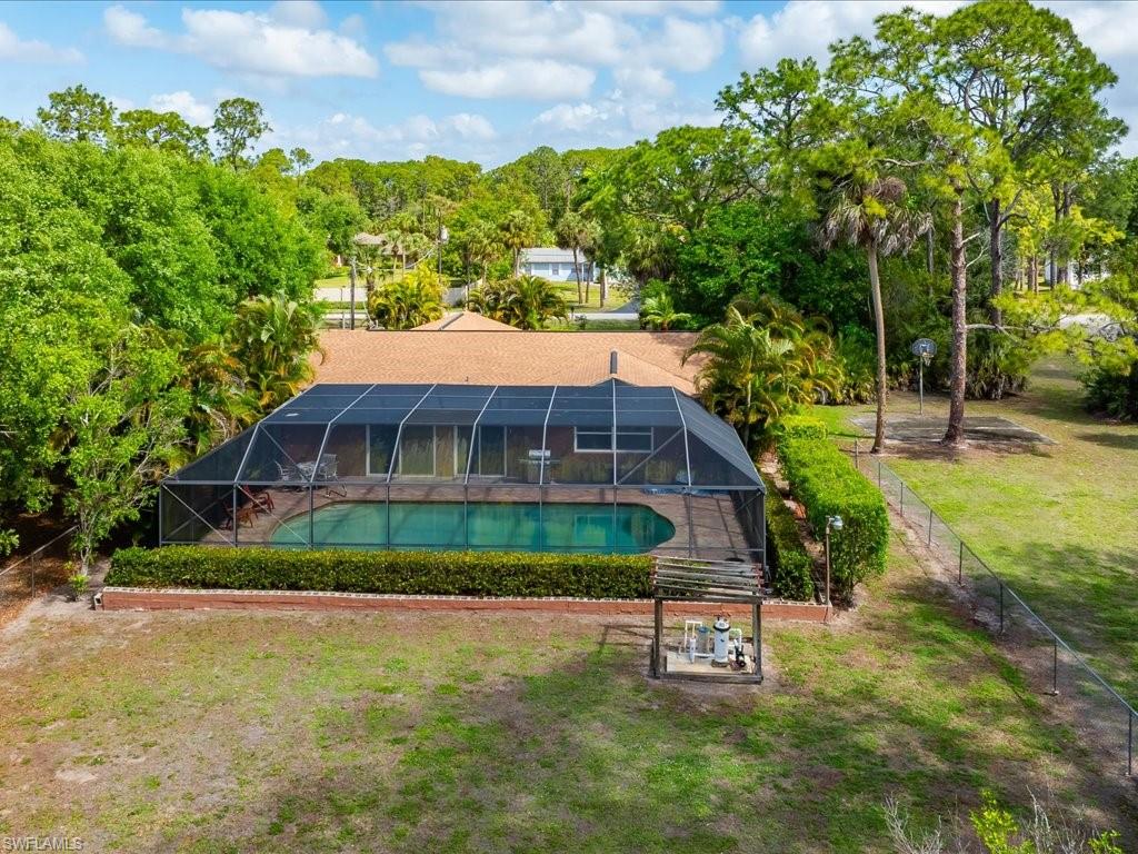 3890 27th Avenue Southwest Naples, FL 34117 - Photo 28 of 38 a view of a house with a yard and sitting area