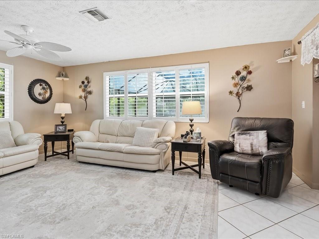 3890 27th Avenue Southwest Naples, FL 34117 - Photo 10 of 38 a living room with furniture and a large window