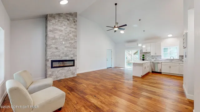 a living room with a bed furniture and next to a window