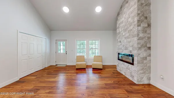 a view of kitchen with kitchen island microwave and cabinets