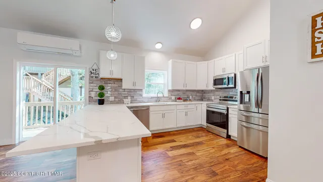 a kitchen with a sink stove and microwave