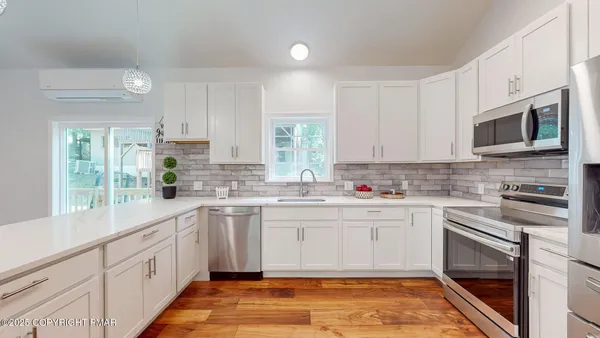 a kitchen with a refrigerator stove and wooden cabinets