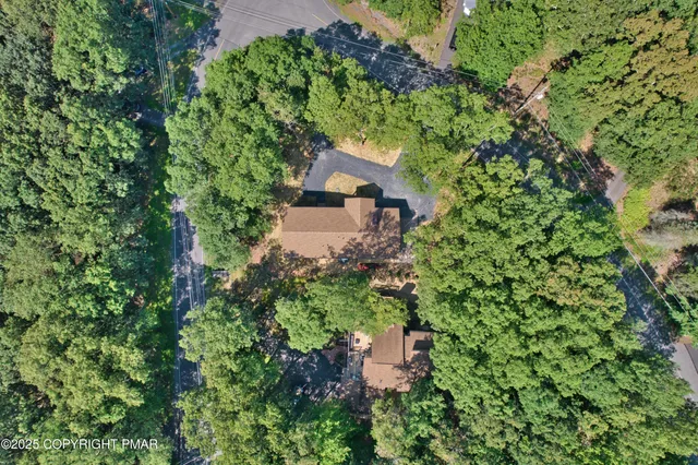 an aerial view of a house with a yard