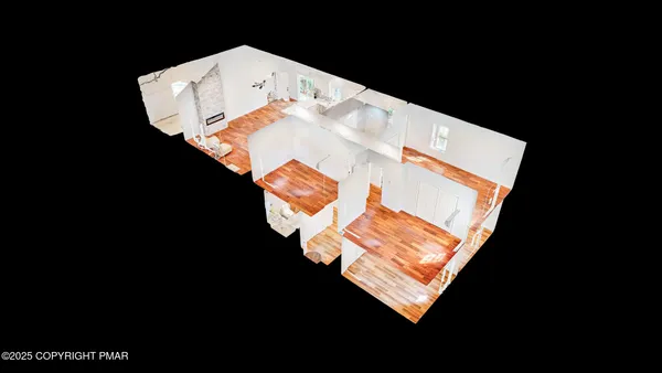 an aerial view of a house with a yard and large trees