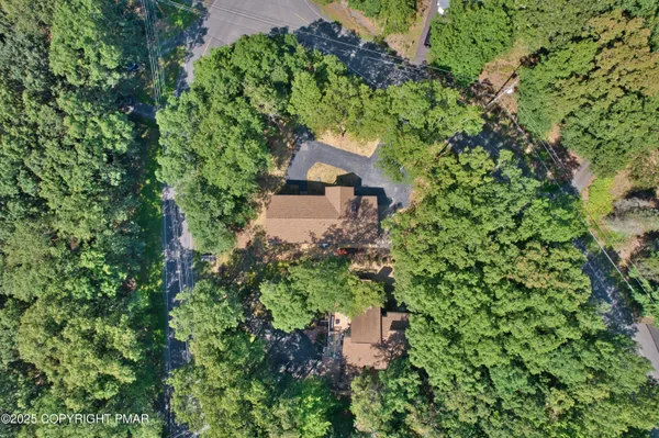 an aerial view of a house with a yard