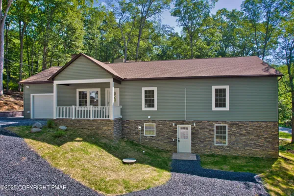 a front view of a house with garden