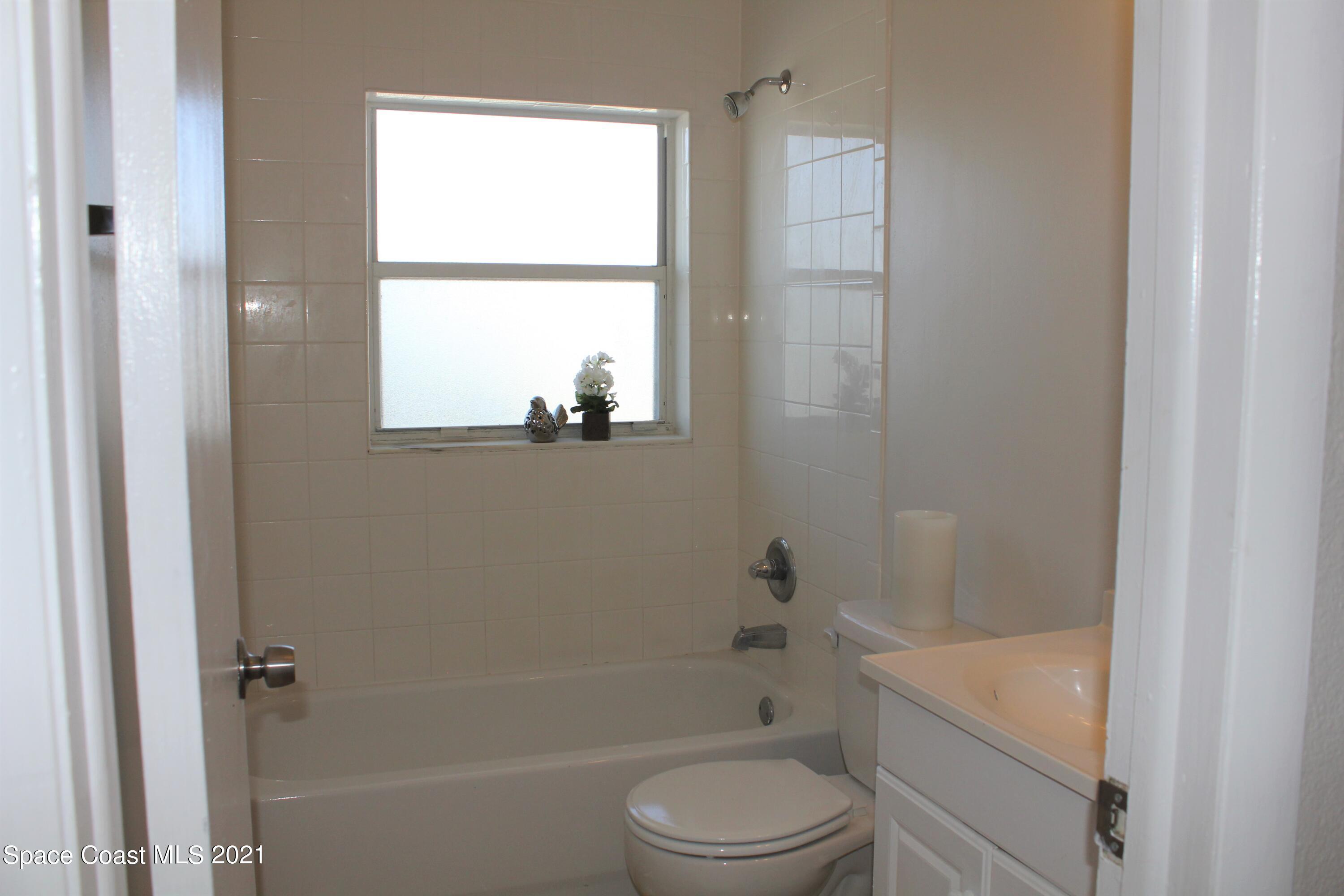 651 Palm Drive, Unit E3 Satellite Beach, FL 32937 - Photo 14 of 25 a bathroom with a sink a toilet and shower