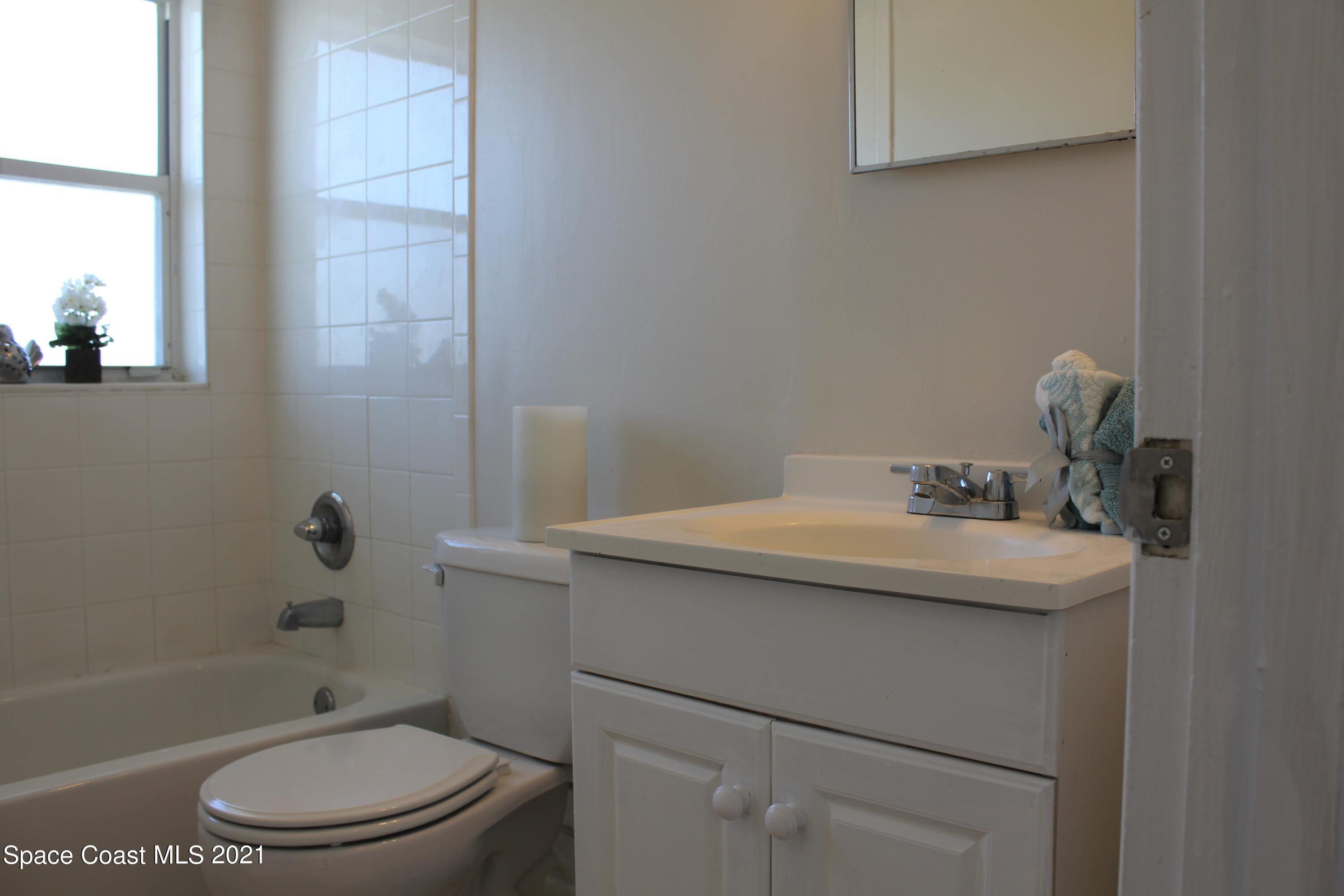 651 Palm Drive, Unit E3 Satellite Beach, FL 32937 - Photo 15 of 25 a bathroom with a sink a toilet and shower