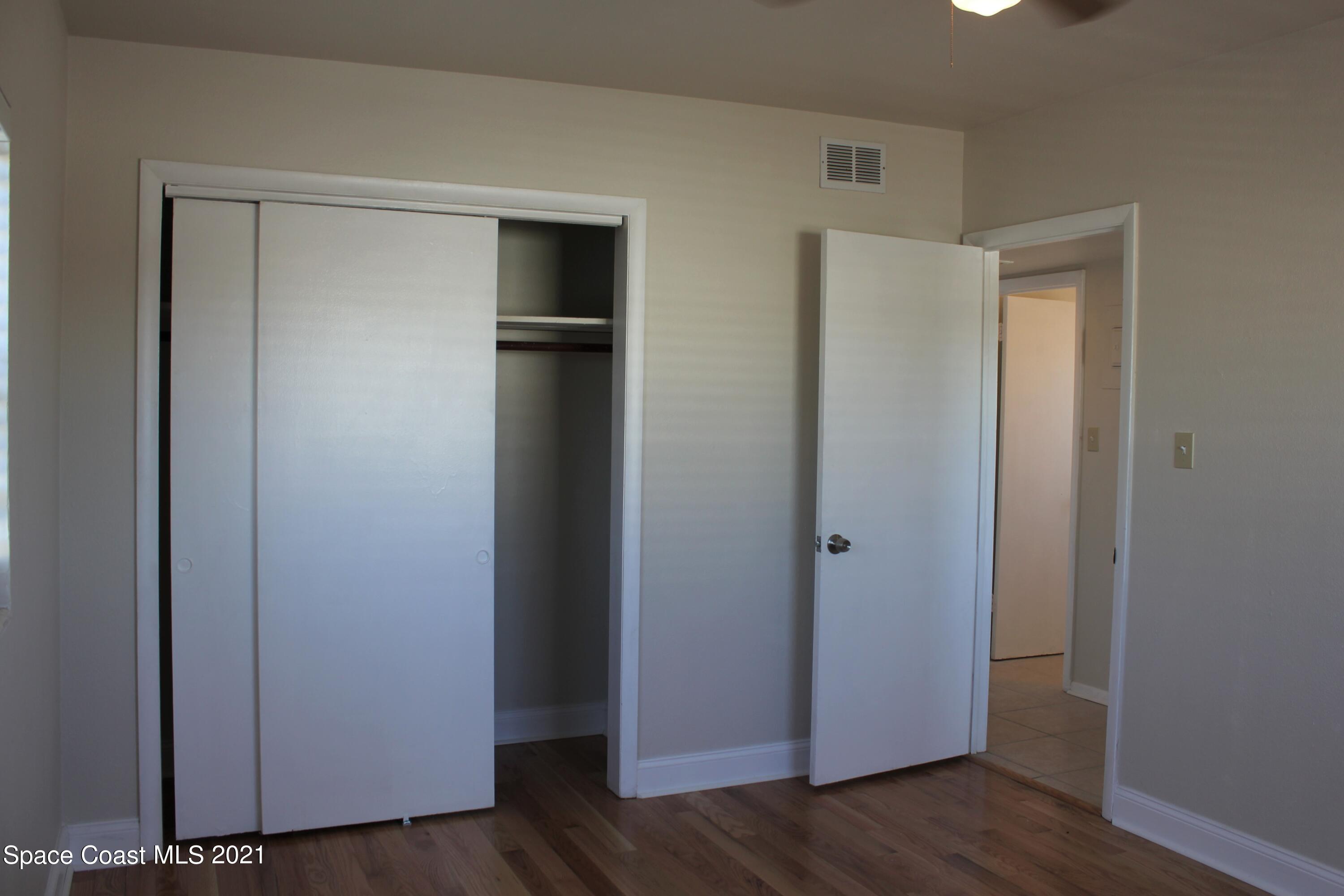 651 Palm Drive, Unit E3 Satellite Beach, FL 32937 - Photo 20 of 25 a view of empty room with wooden floor