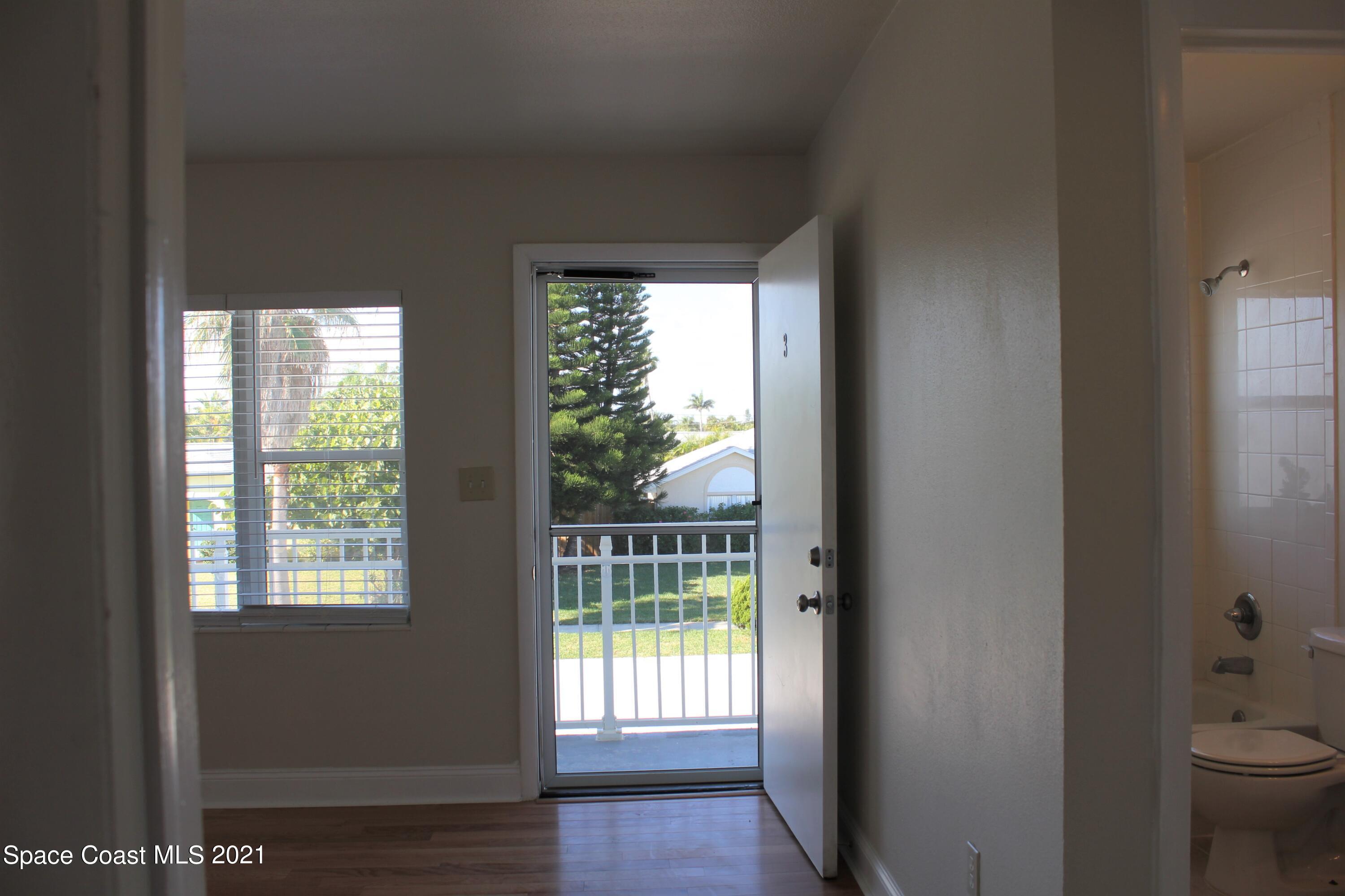 651 Palm Drive, Unit E3 Satellite Beach, FL 32937 - Photo 3 of 25 a view of a room that has a bed in it