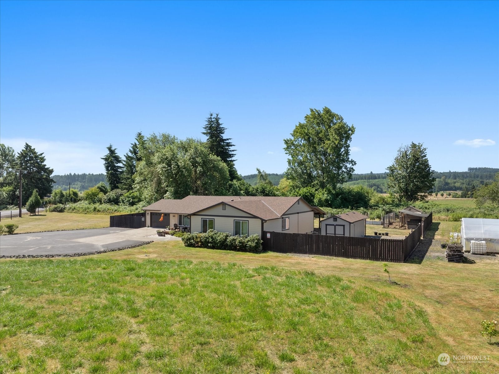 366 Twin Oaks Road Chehalis, WA 98532 - Photo 31 of 40 a view of swimming pool with seating area and trees in the background