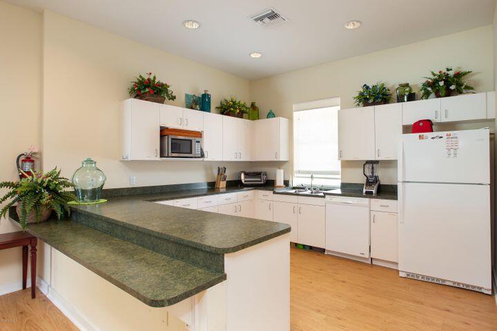 3750 Alamanda Key Drive Melbourne, FL 32901 - Photo 63 of 86 a kitchen with granite countertop a sink and white appliances