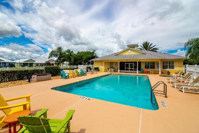 3750 Alamanda Key Drive Melbourne, FL 32901 - Photo 69 of 86 a front view of a house with swimming pool having outdoor seating