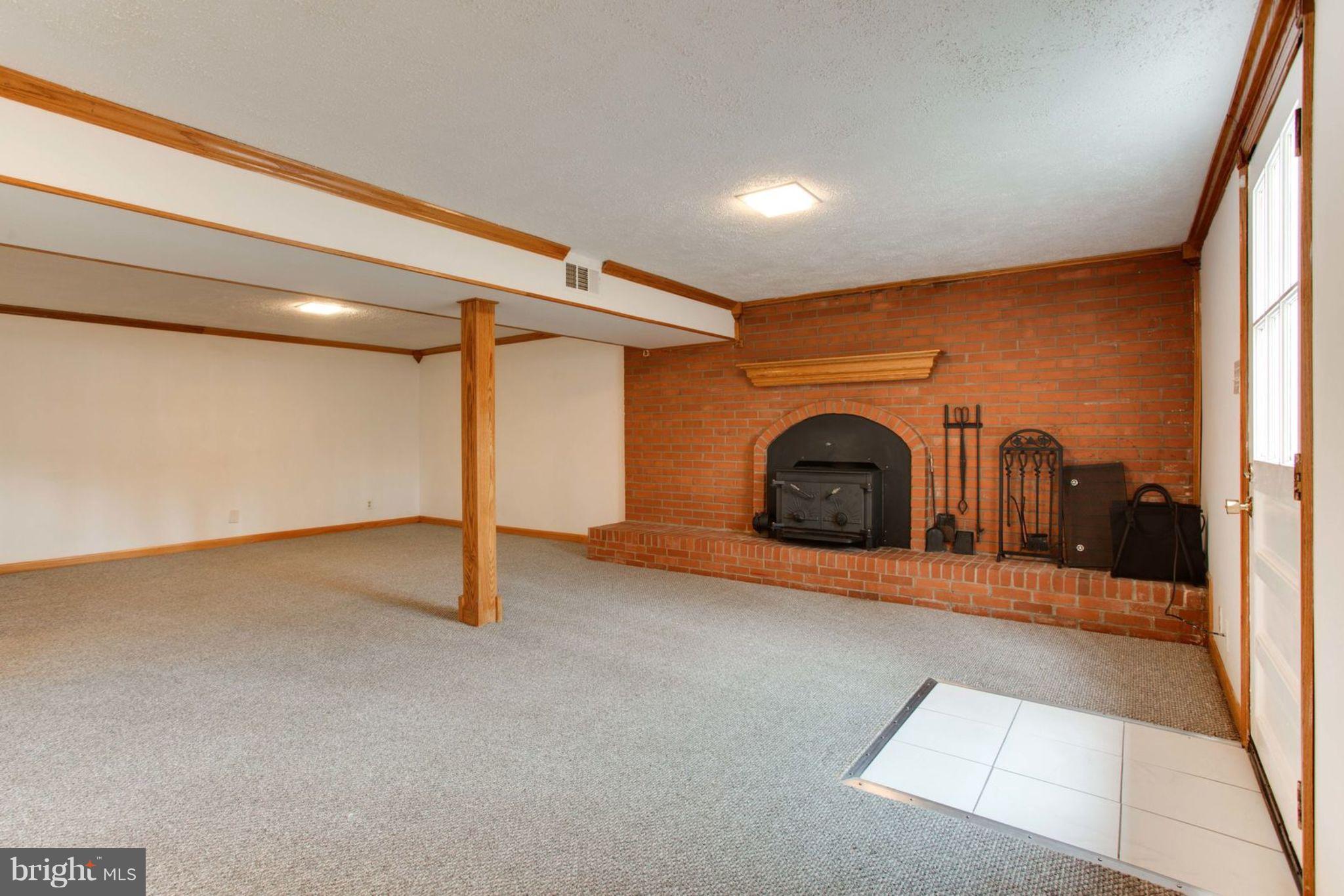 8001 Ronald Road Manassas, VA 20112 - Photo 36 of 50 Basement Rec Room with Brick Wood Stove