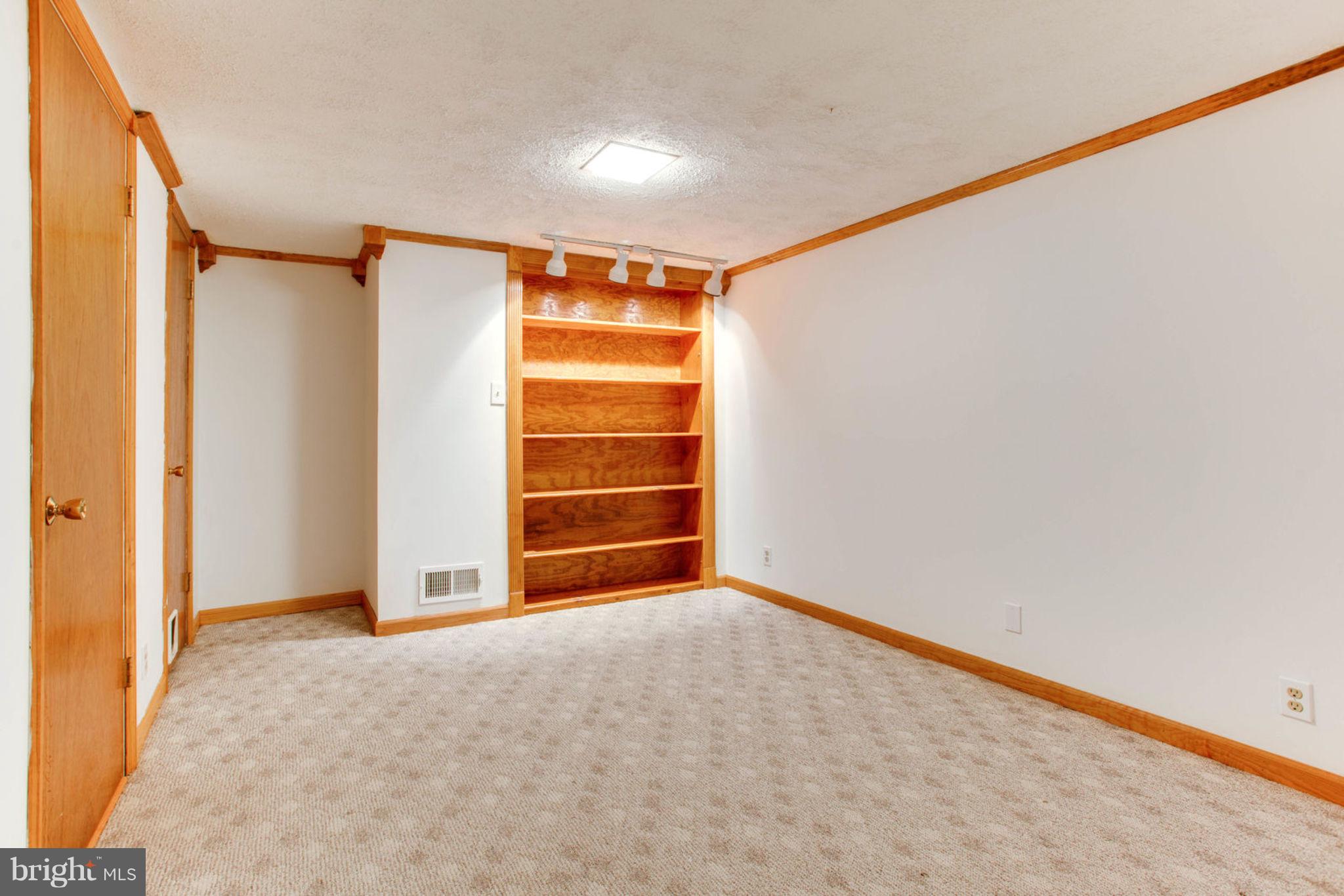 8001 Ronald Road Manassas, VA 20112 - Photo 40 of 50 Basement Room with Built ins and Crown Molding
