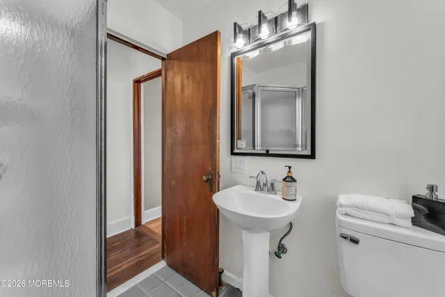 a bathroom with a sink a mirror and a toilet