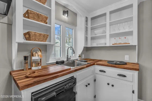 a kitchen with a stove a microwave and cabinets