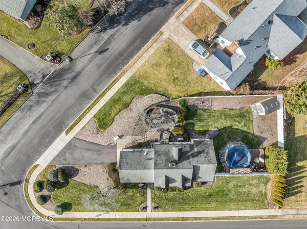 an aerial view of a house with a garden and patio