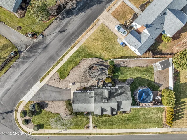 an aerial view of a house with a garden and patio