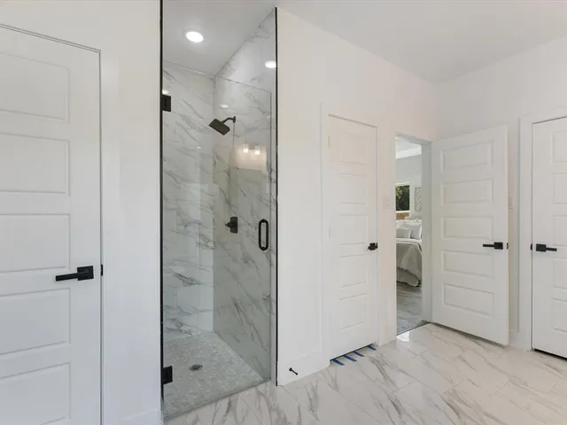 a bathroom with a shower and a glass door
