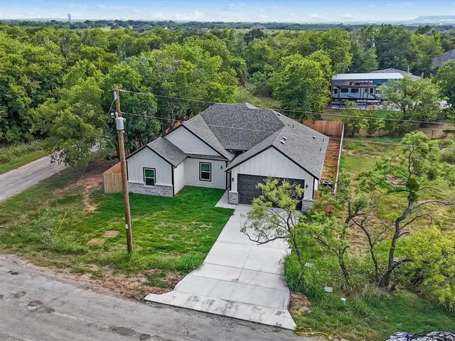 a house with green field in front of it