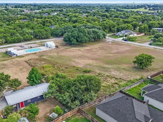 an aerial view of a houses with a yard