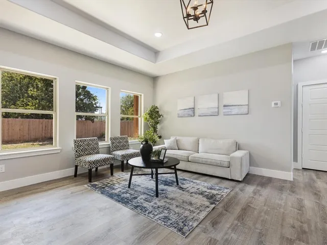 a living room with furniture and a large window