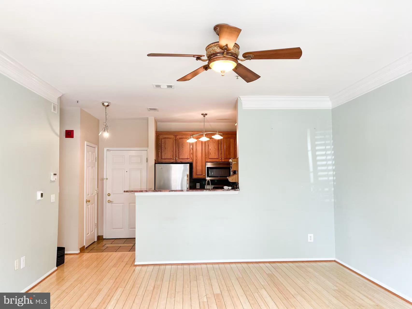 1570 Spring Gate Dr., Unit 7109 McLean, VA 22102 - Photo 13 of 21 a view of a room with a window and wooden floor