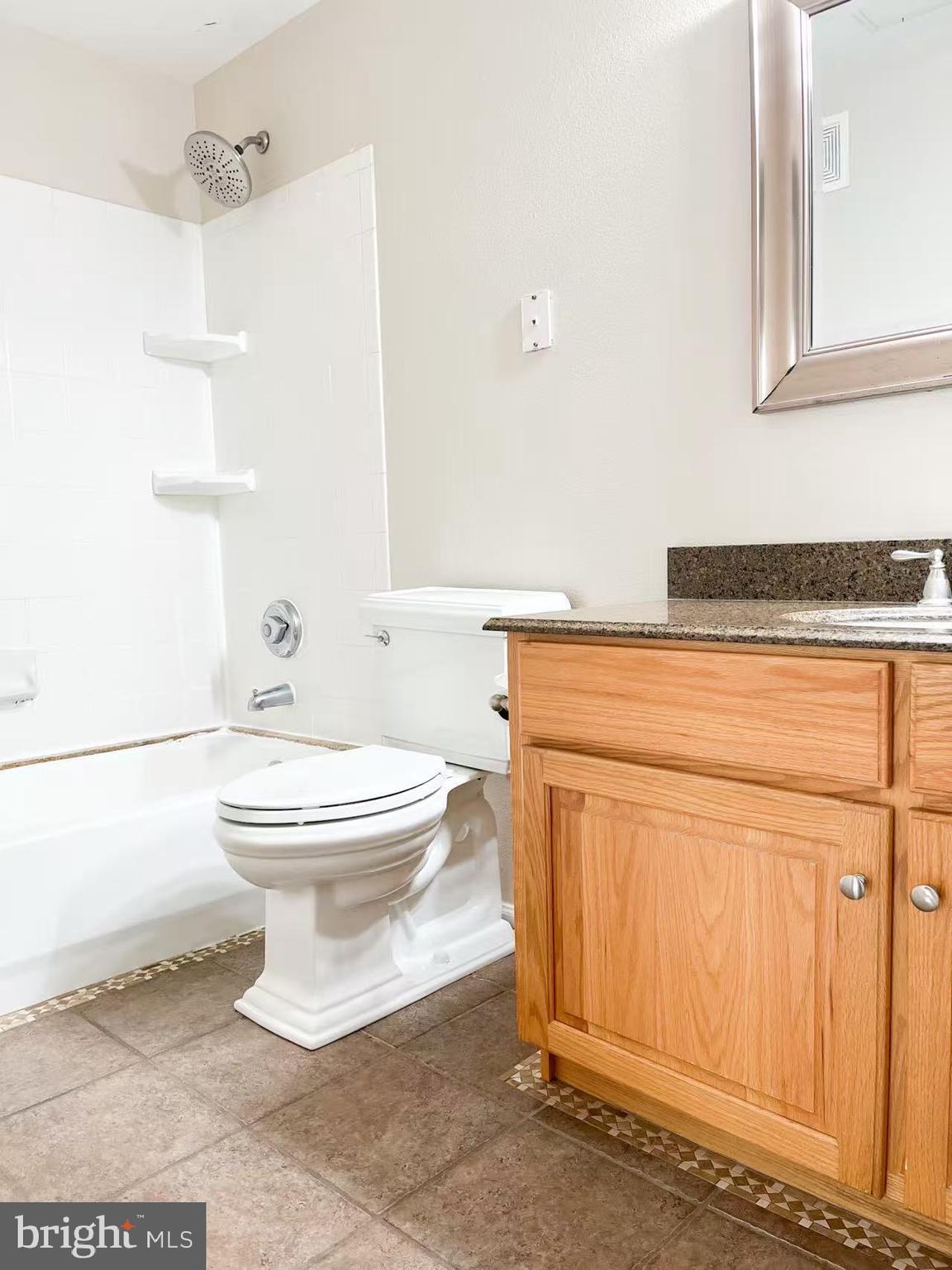 1570 Spring Gate Dr., Unit 7109 McLean, VA 22102 - Photo 18 of 21 a bathroom with a toilet a sink and bathtub