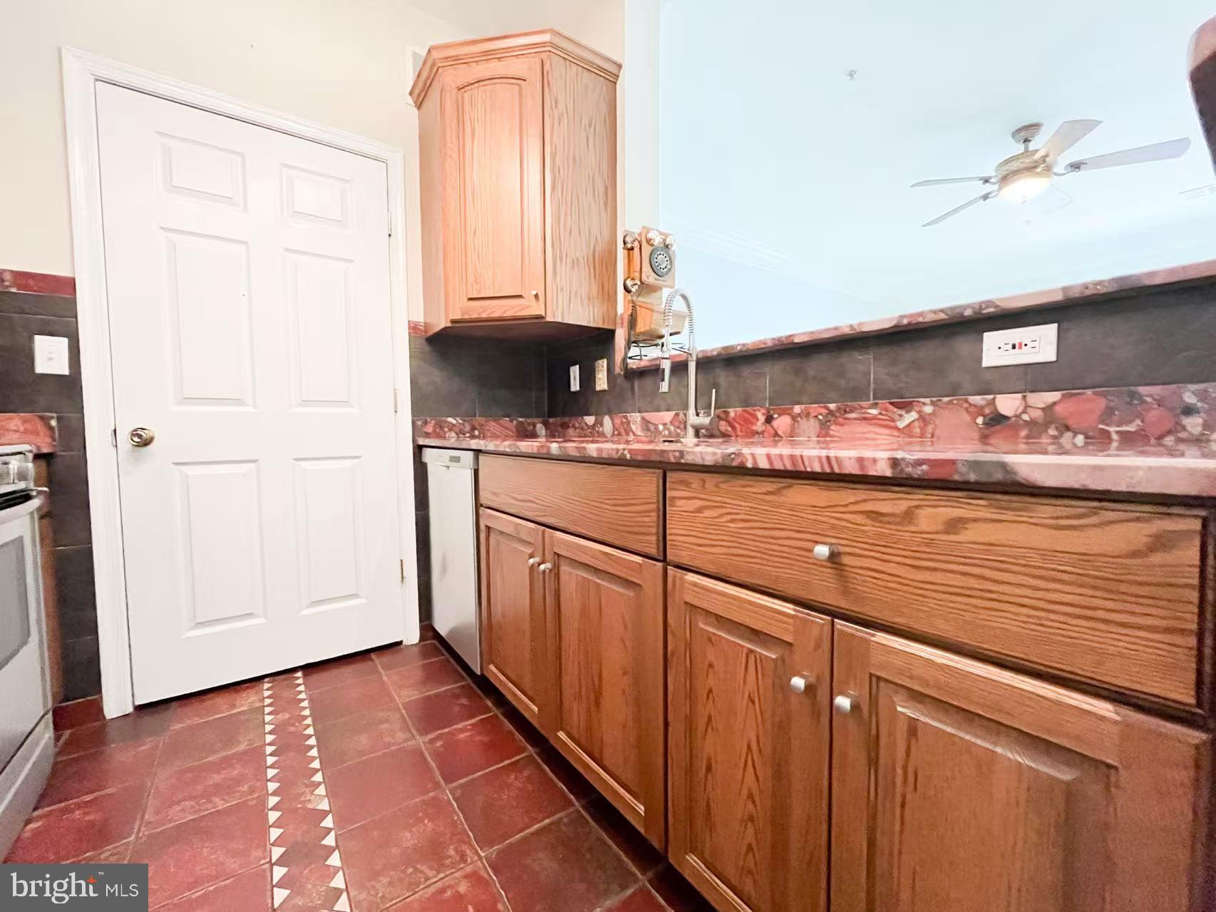 1570 Spring Gate Dr., Unit 7109 McLean, VA 22102 - Photo 6 of 21 a kitchen with stainless steel appliances granite countertop a sink and cabinets