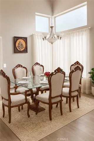 a dining room with furniture and a chandelier