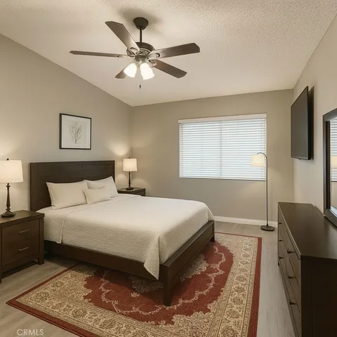 a bedroom with a large bed and a chandelier