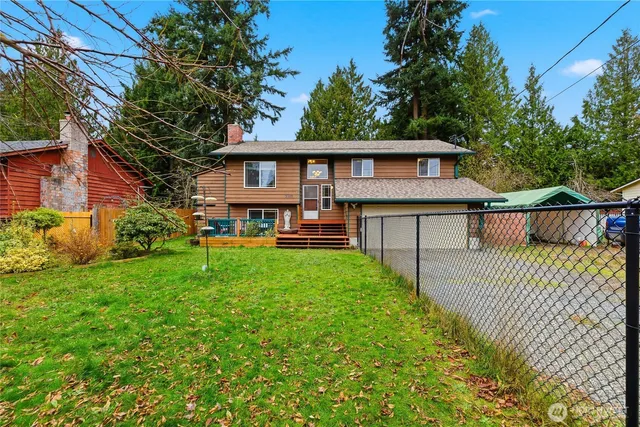 a view of a house with a yard and deck