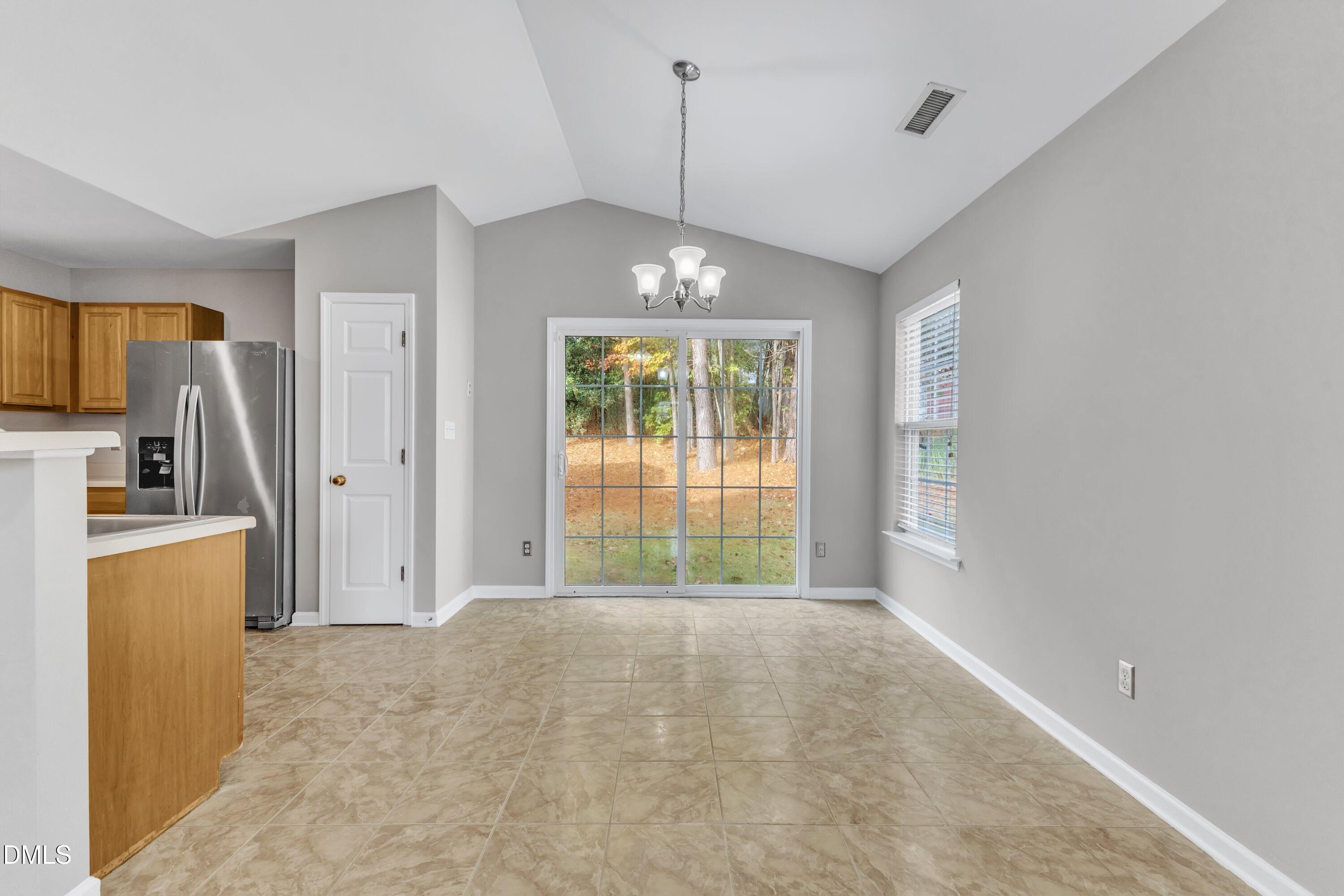 4917 Silverdene Street Raleigh, NC 27616 - Photo 12 of 35 a view of a kitchen with a stove cabinets and a window