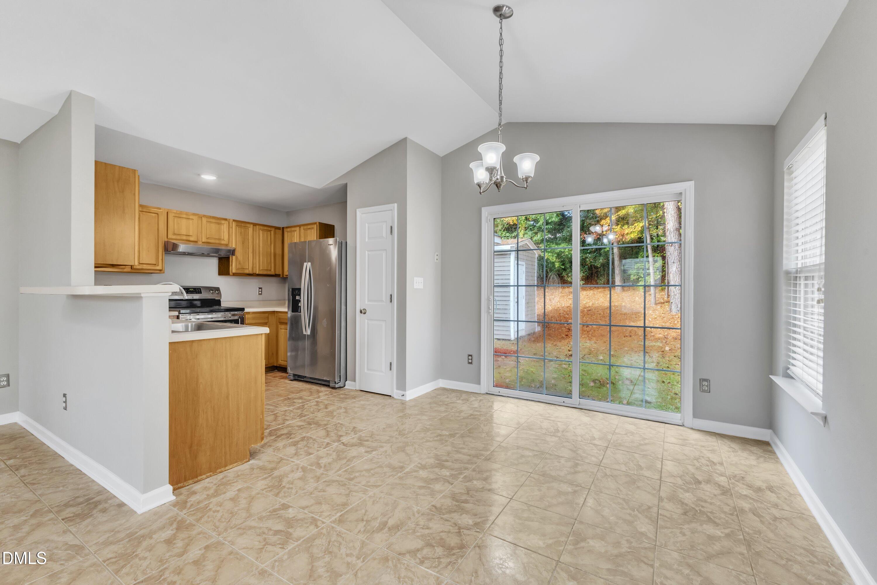4917 Silverdene Street Raleigh, NC 27616 - Photo 13 of 35 a open kitchen with refrigerator a stove top oven a sink and dishwasher with wooden floor